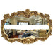 Decorative gold mirror with intricate designs reflecting a living room.