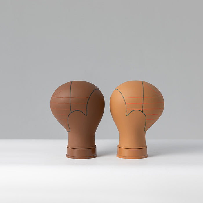 Two brown ceramic vases with abstract designs on a gray background