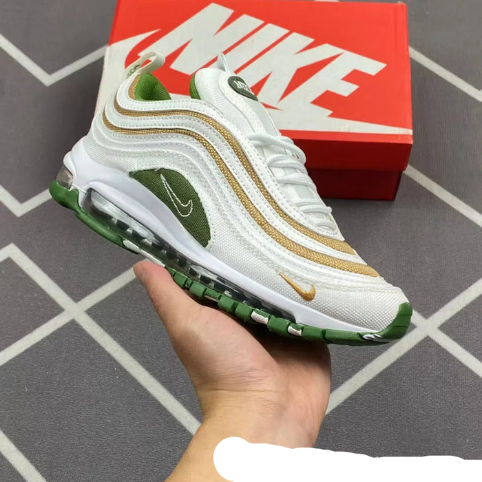 White and green sneaker with gold accents held in front of a red Nike box.