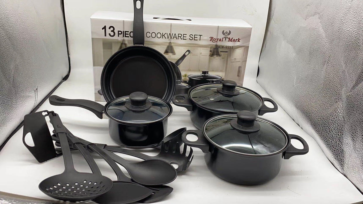 13-piece cookware set with black pots, pans, and utensils on a white surface.