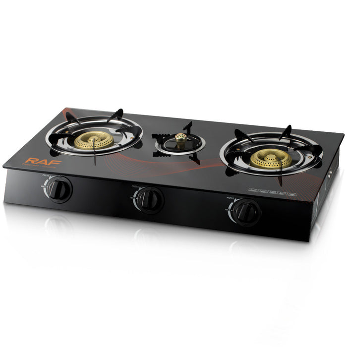 Three-burner gas stove with black glass top on a white background