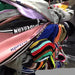 Collection of scarves with various patterns and colors on a rack.