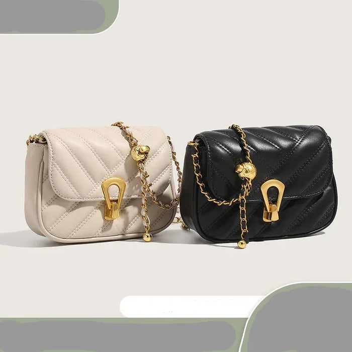 Two quilted handbags, one beige and one black, with gold chains on a light gray background.