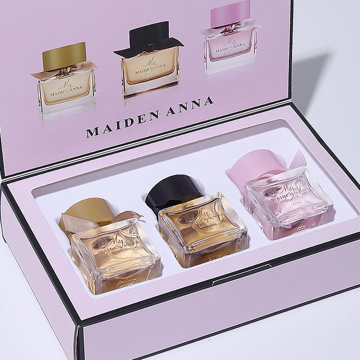 Set of Maiden Anna perfume bottles in a display box on a light pink background