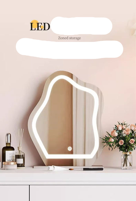 LED lighted vanity mirror on a dresser with decorative items.