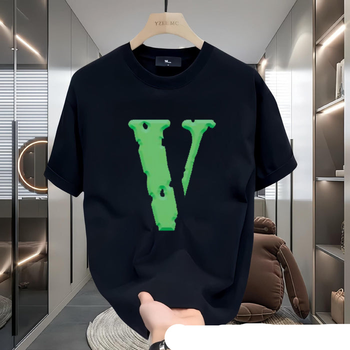 Black t-shirt with green logo on a hanger in a modern interior setting