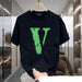 Black t-shirt with green logo on a hanger in a modern interior setting