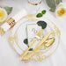 Decorative table setting with gold cutlery, ornate plate, and white roses on a white background.