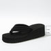 Black wedge sandal on a white background