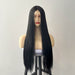 Black wig on a mannequin head against a plain background