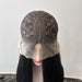 Mannequin head with a black lace wig cap and long black hair on a white background