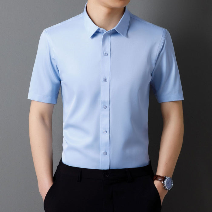 Light blue short-sleeve dress shirt worn by a person on a gray background