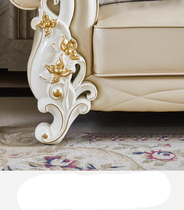 Decorative leg of a piece of furniture with intricate gold detailing on a carpeted floor.