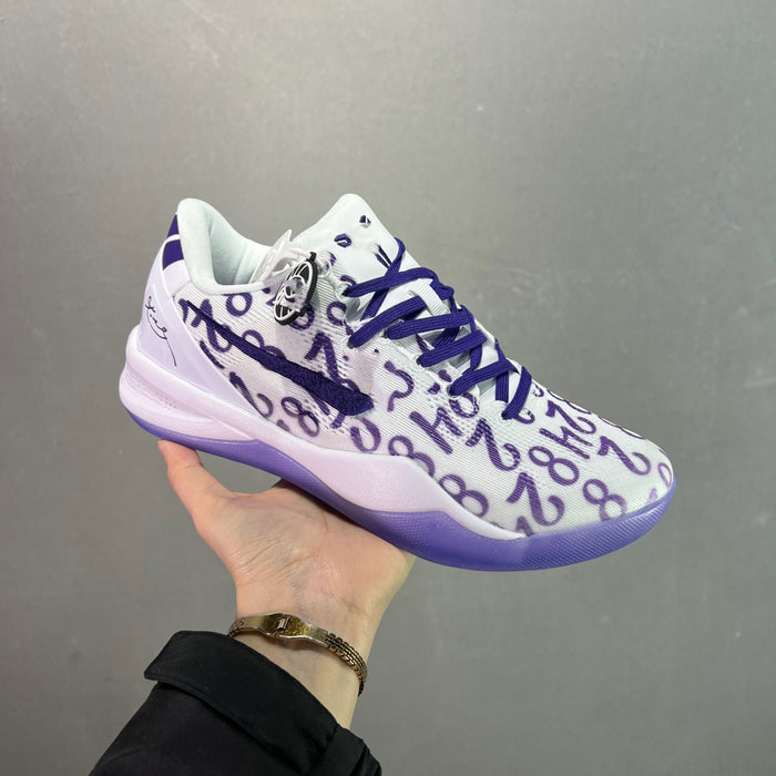 White sneaker with purple accents held by a hand against a gray background