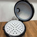 Black and white steamer basket with lid on a wooden surface