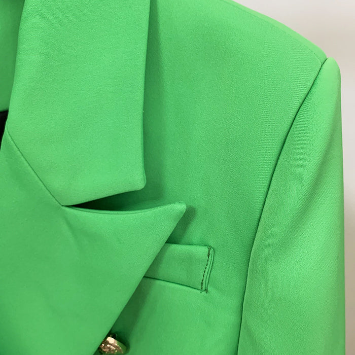 Close-up of a green coat with a collar and button detail.