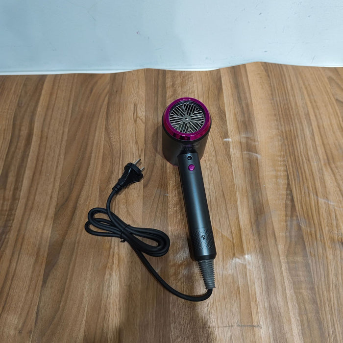 Black hair dryer with purple accents on a wooden surface