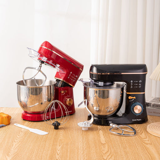 Two stand mixers, one red and one black, on a wooden surface with various attachments.