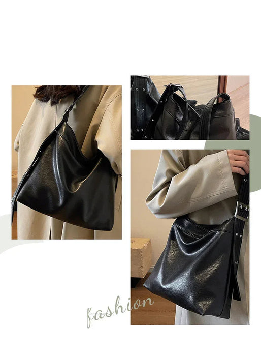 Black handbag being held by a person with a neutral background