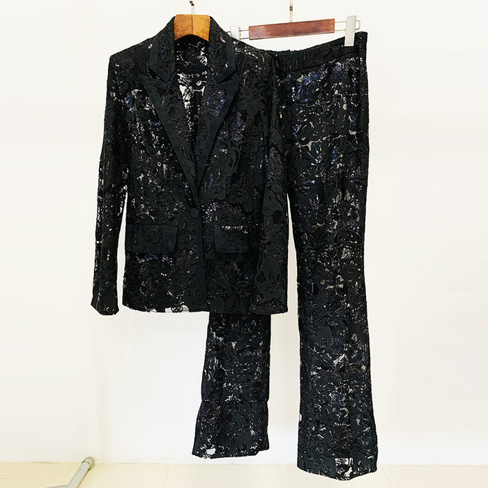 Black sequin suit on a hanger against a white background