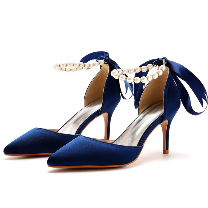 Blue high-heeled shoes with pearl straps on a white background