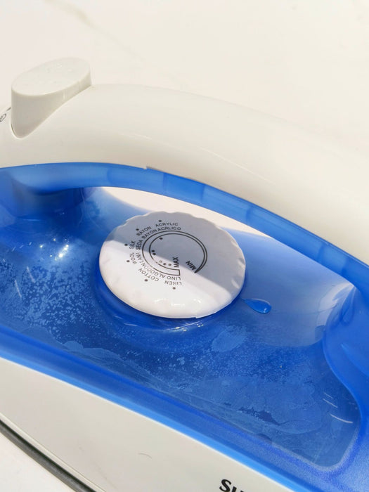 Close-up of a white and blue iron with a visible brand logo on a white background