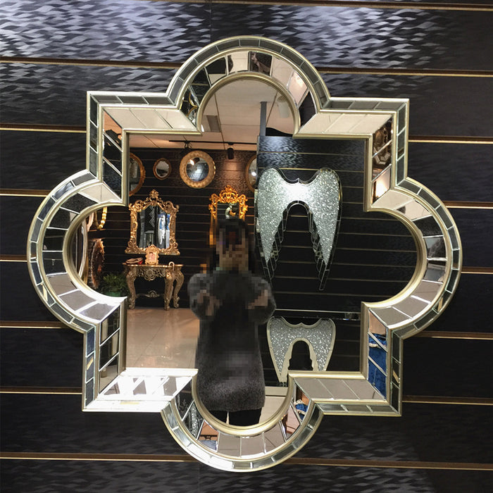 Decorative mirror with intricate design on a dark wall