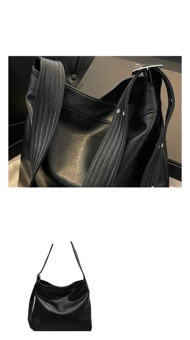Black handbag with a magnetic clasp on a dark background