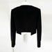 Black jacket with gold accents on a white background
