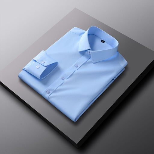Folded light blue dress shirt on a dark surface