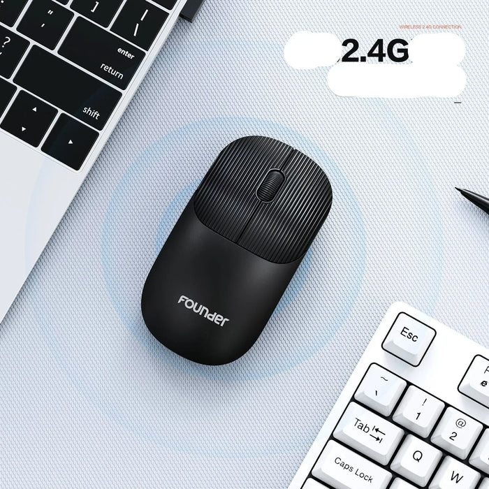 Black wireless mouse on a desk with a laptop and keyboard in the background