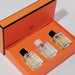 Three perfume bottles in an orange box with a visible brand logo.