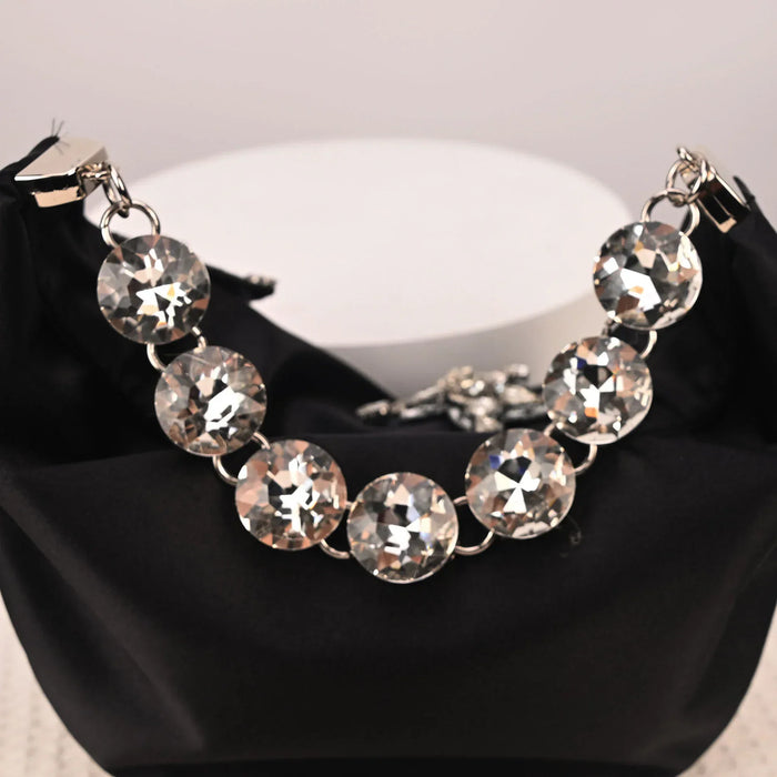 Necklace with large crystal beads on a black surface