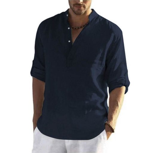 Man wearing a navy blue shirt with rolled-up sleeves on a white background