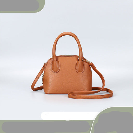 Brown handbag with a strap on a light gray background