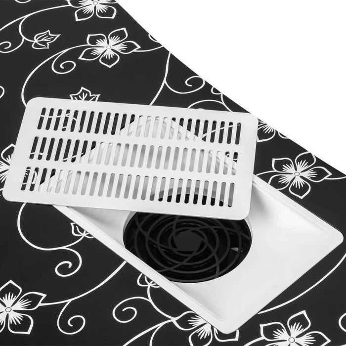 White floor vent cover on a black and white floral patterned surface