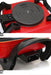 Close-up of a red and black portable stove with visible branding on a white background