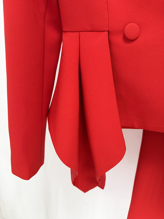 Close-up of a red coat with a button on a white background