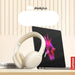 White headphones next to a Lenovo laptop with colorful design on a beige background