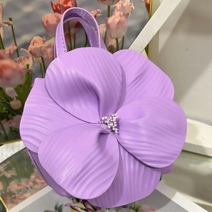 Purple flower-shaped handbag with floral background