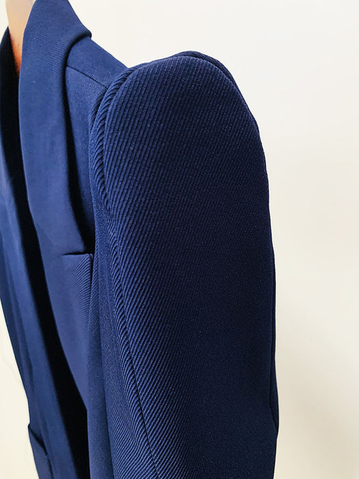 Close-up of a blue blazer on a beige background