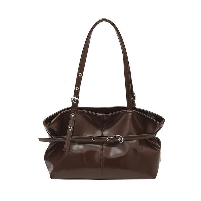 A dark brown leather shoulder bag with a structured slouchy silhouette, featuring a front horizontal strap detail with silver-tone grommets and a buckle, set against a plain white background.