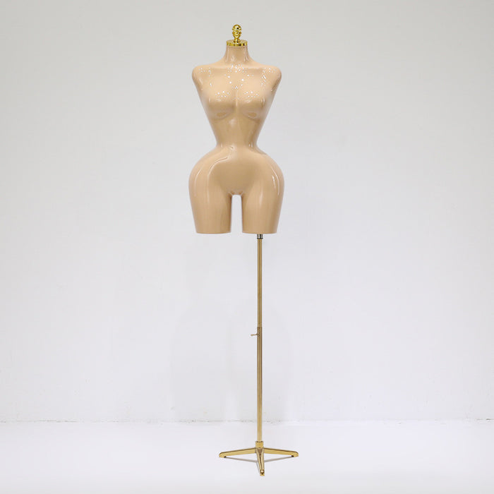 Mannequin torso on a stand against a white background