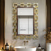 Decorative wall mirror with geometric frame in a bathroom setting