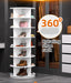 White rotating shoe rack with various shoes and handbags in a room setting.