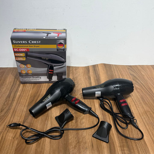 Black hair dryer with attachments and Slivers Crest packaging on a wooden surface