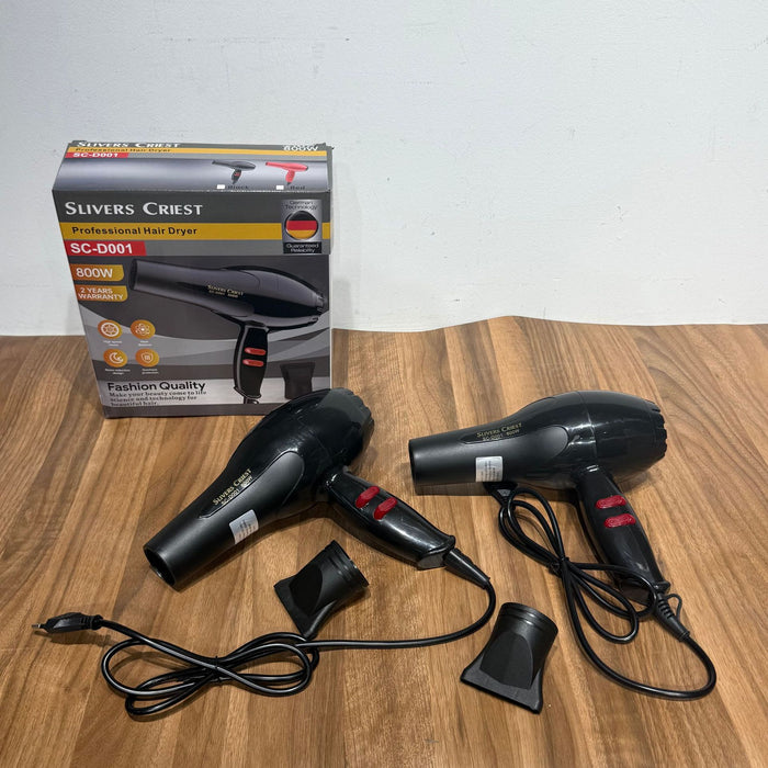 Black hair dryer with attachments and Slivers Crest packaging on a wooden surface