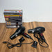 Black hair dryer with attachments and Slivers Crest packaging on a wooden surface
