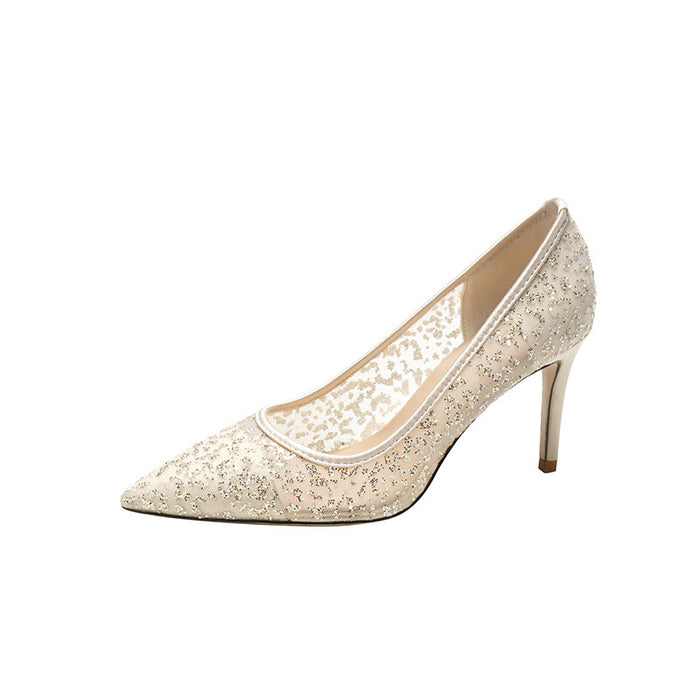 Beige high-heeled shoe with glittery texture on a white background