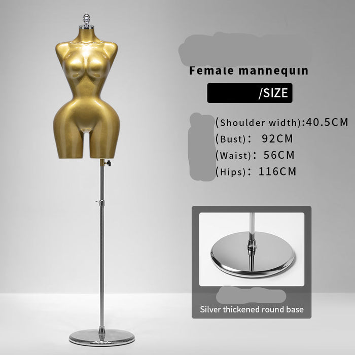 Gold female mannequin with size information on a gray background